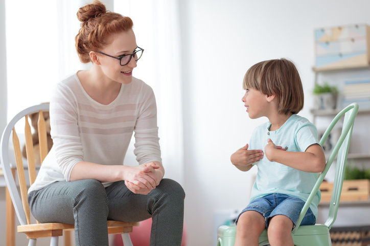 therapist works with young child during a therapy session